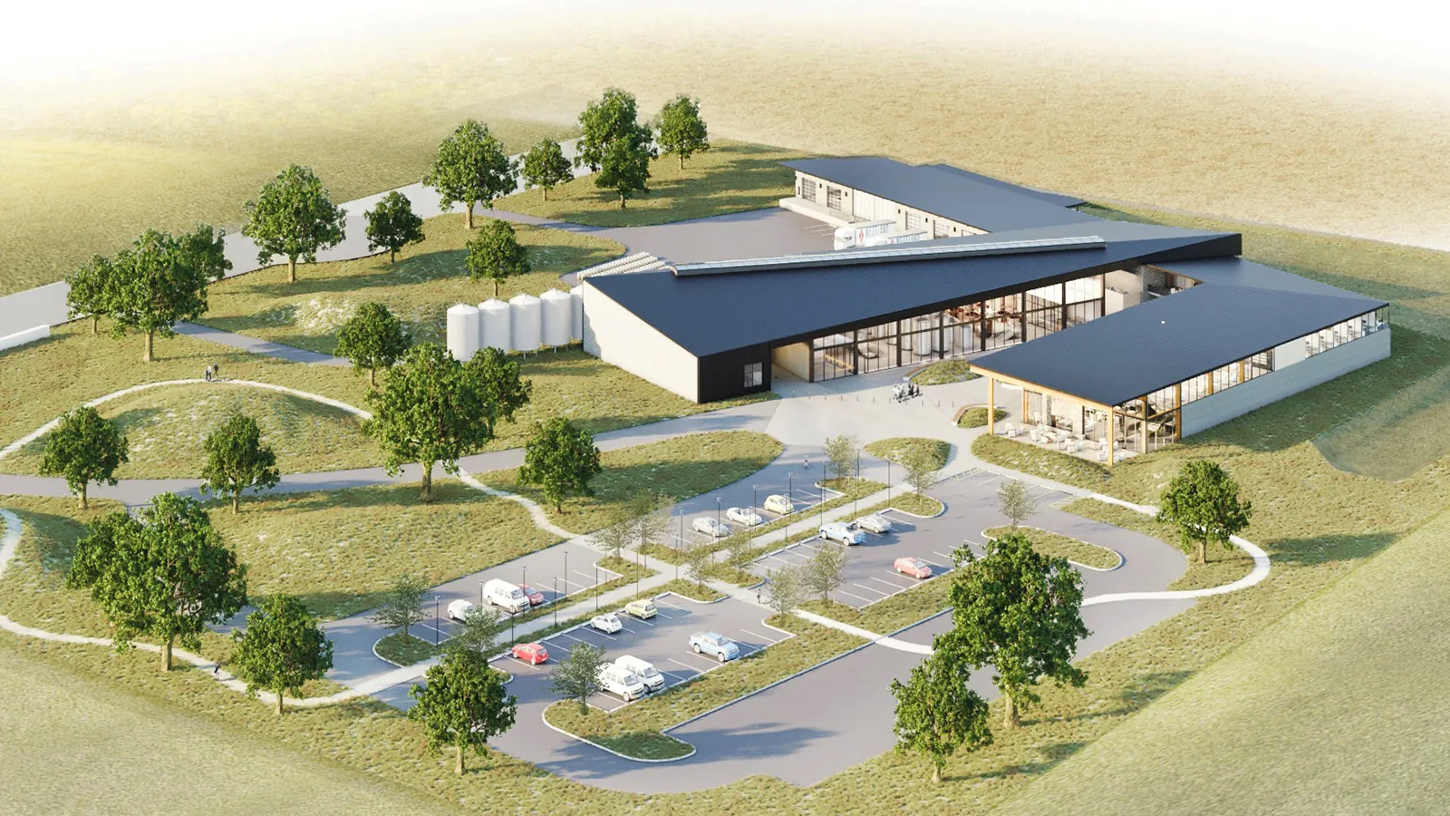 Aerial rendering of a modern distillery campus with dark angled roofs, silos, and green landscaping.