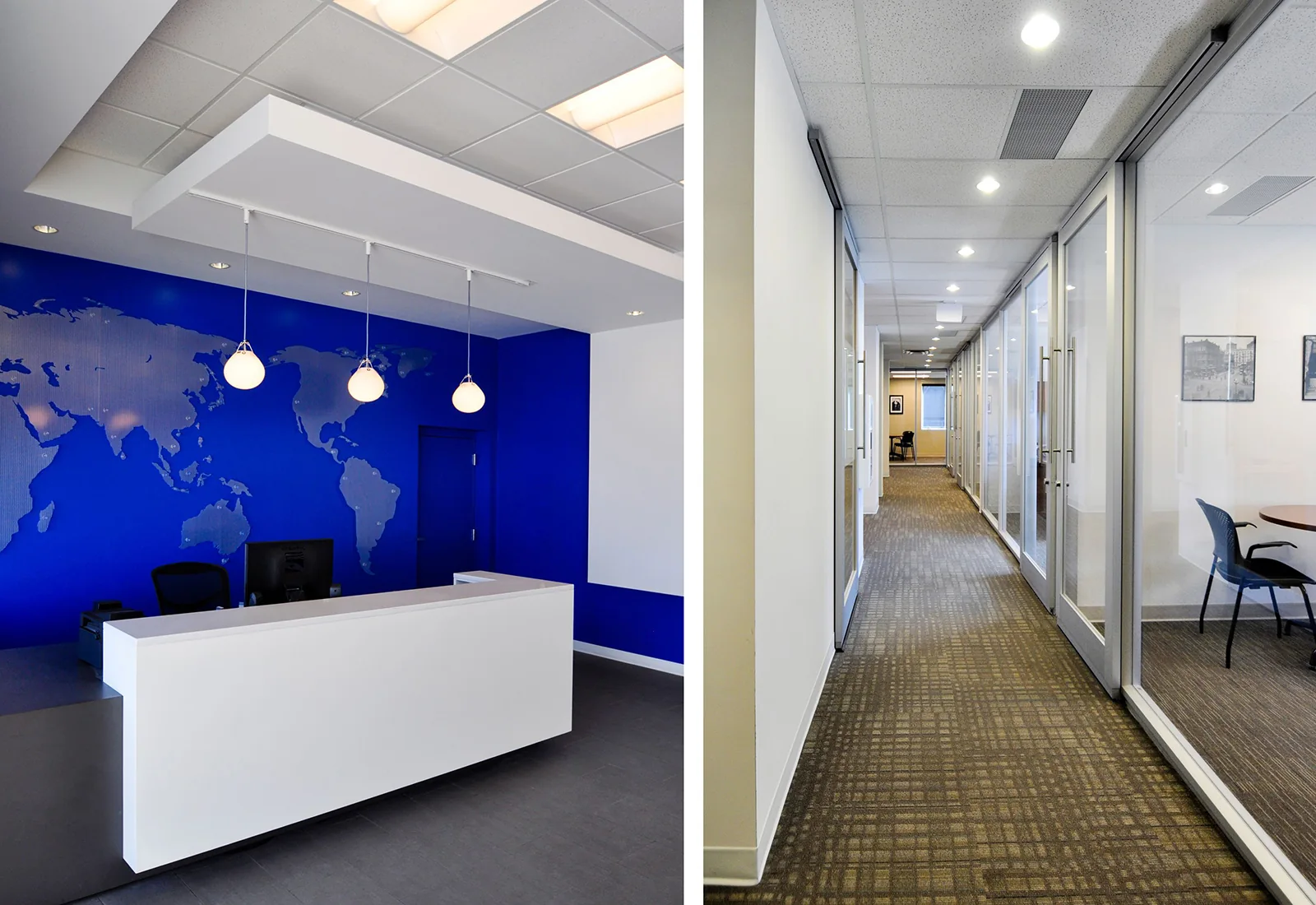 Modern office reception with a blue world map wall and a long hallway lined with glass-walled offices.